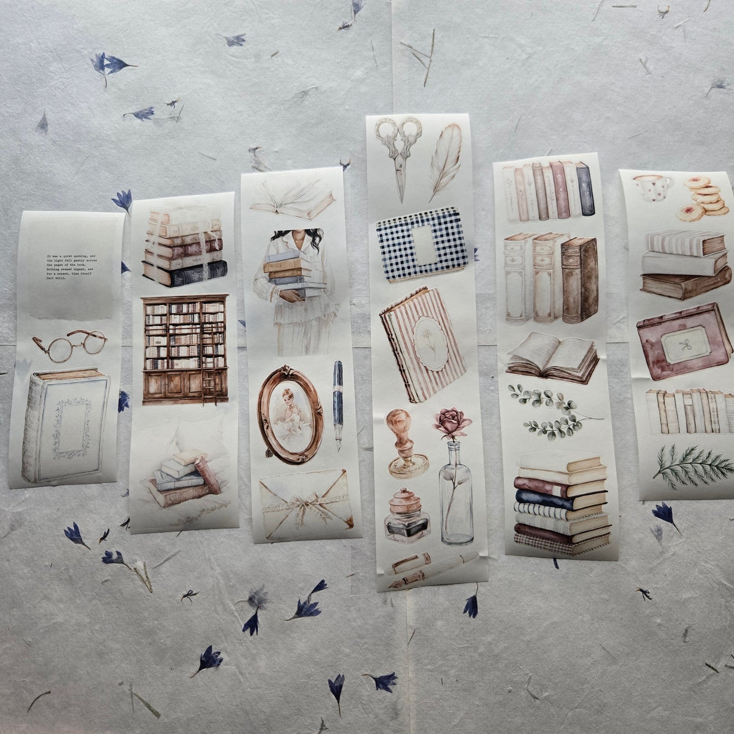 Collection of stationery items including books and stationery on a textured surface.