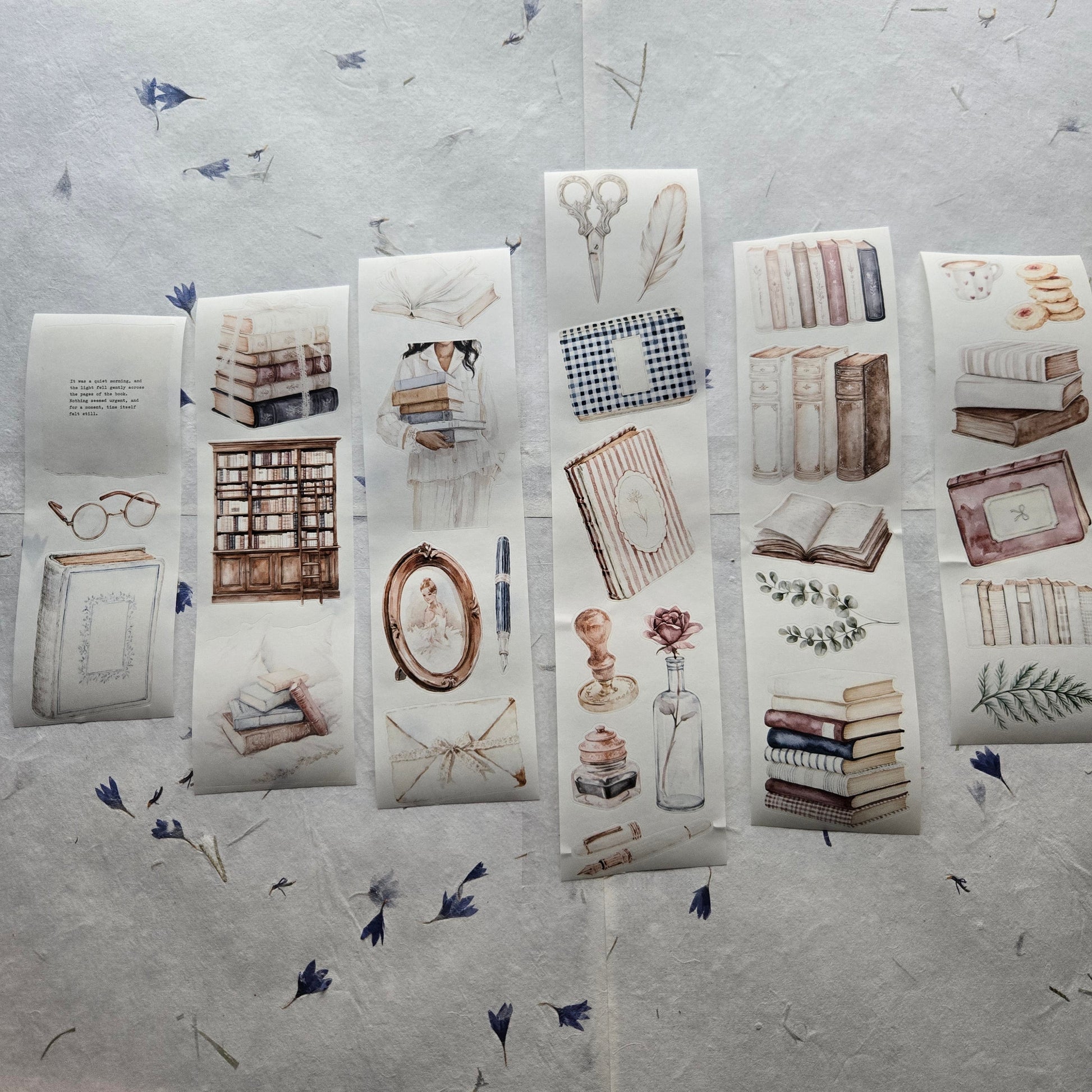 Collection of stationery items including books and stationery on a textured surface.