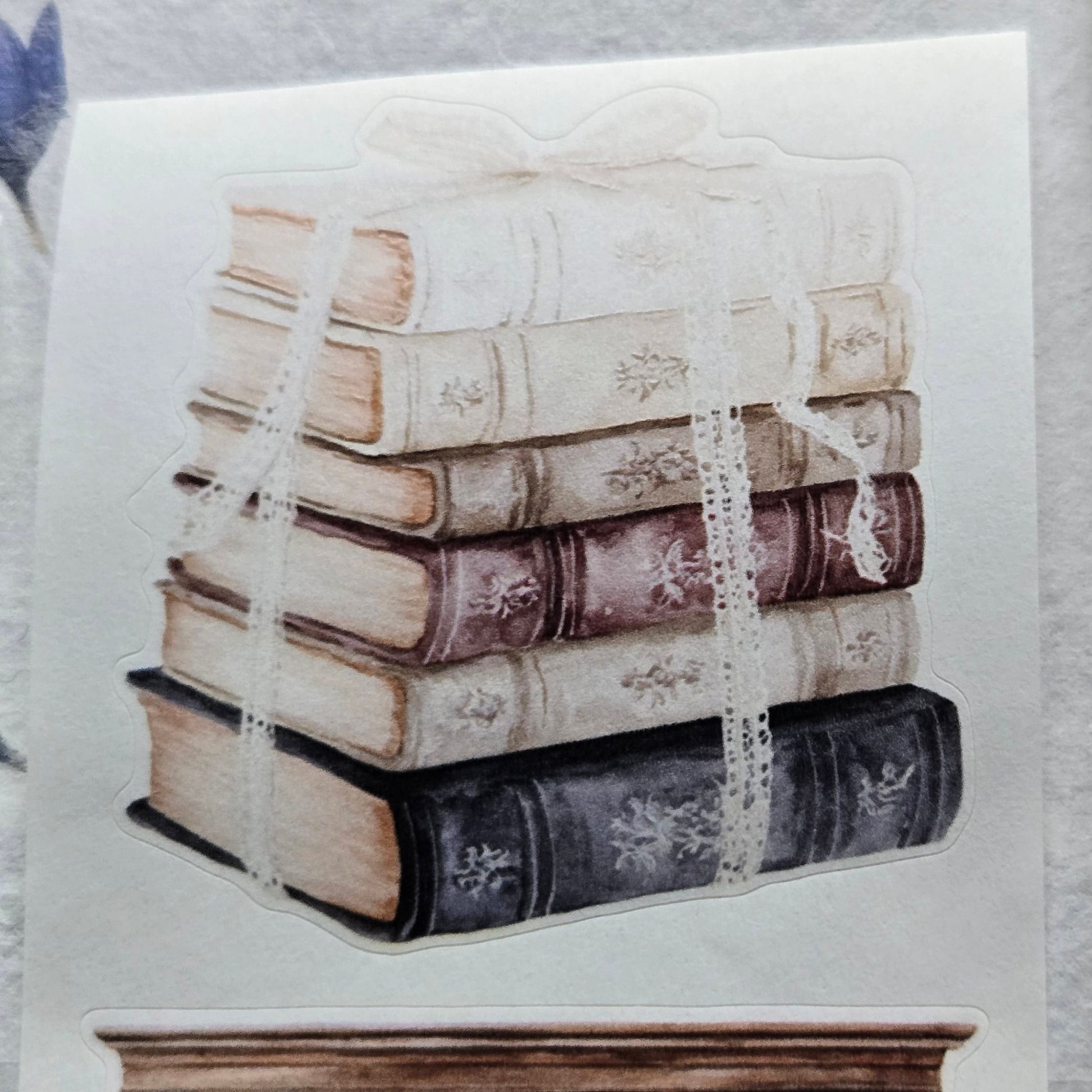 Decorative paper with vintage books design on a textured surface