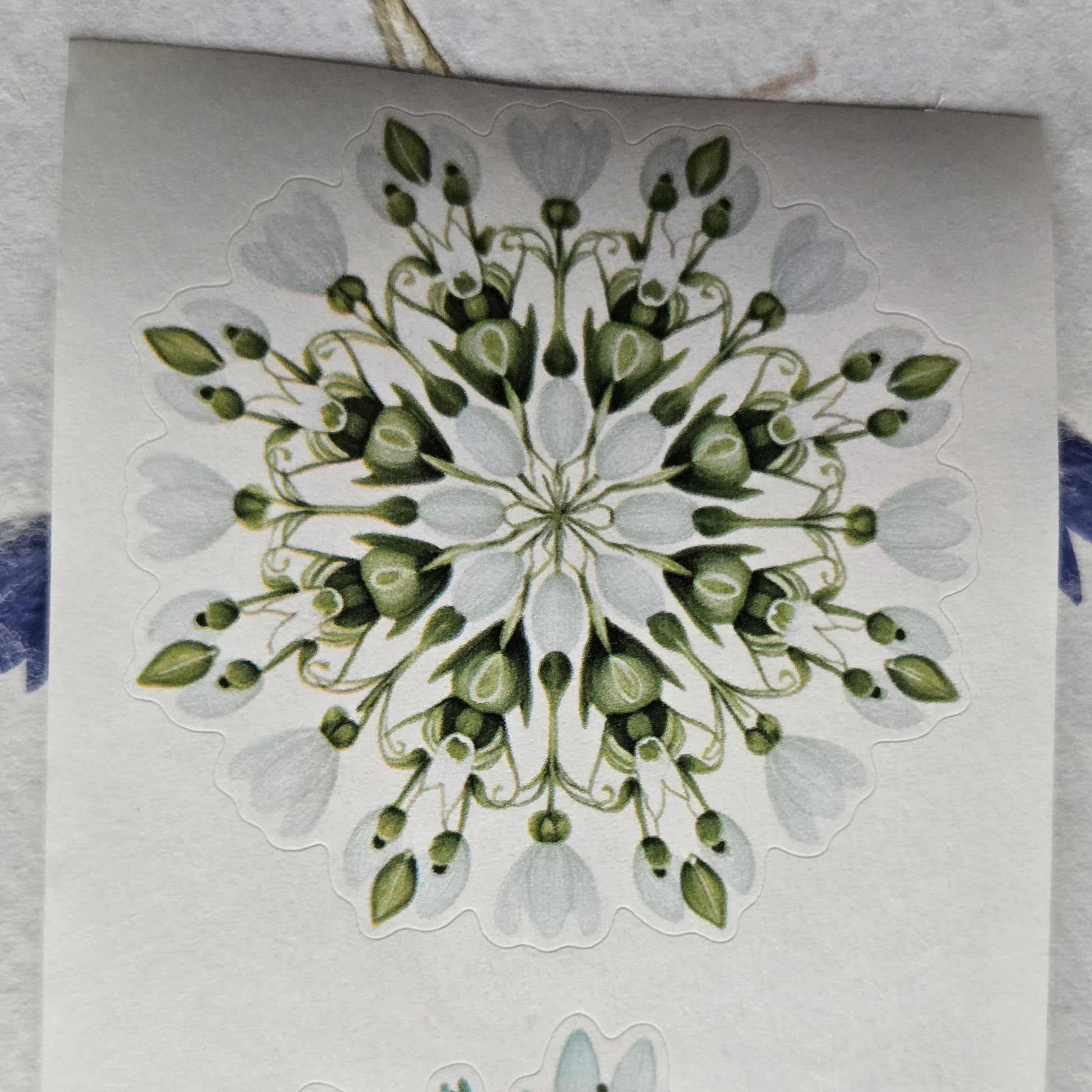 Decorative card with floral designs on a textured surface