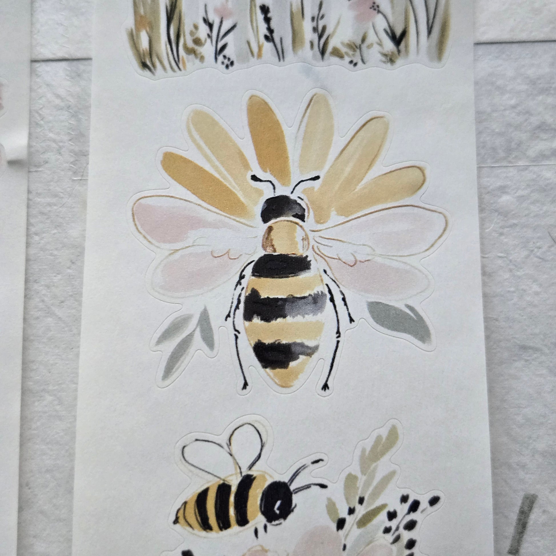 Two bee illustrations on a white background with floral elements.