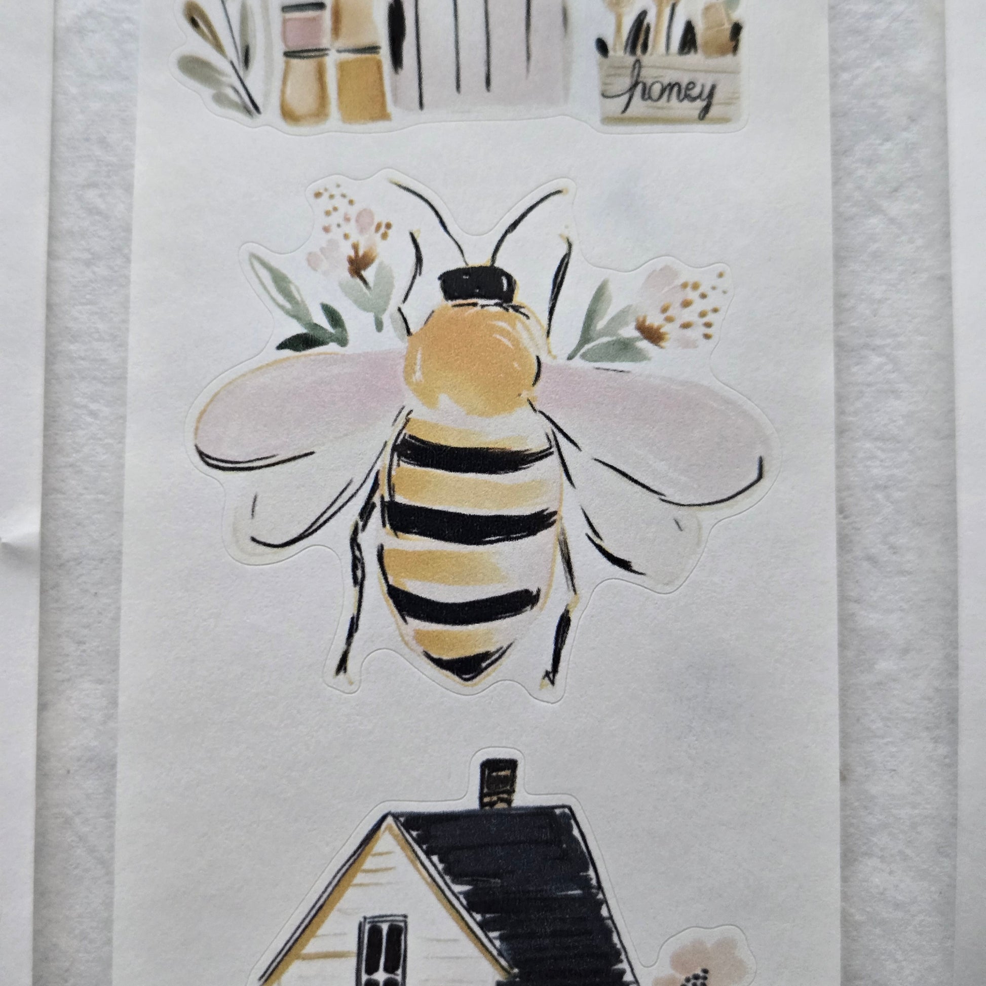 Sticker of a bee and beehive on a white background