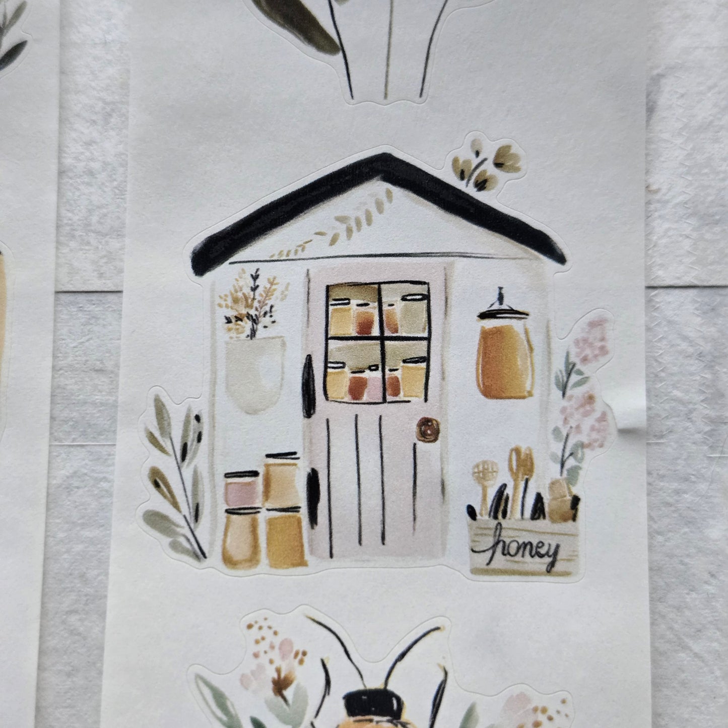 Decorative paper with house and plant designs on a white surface