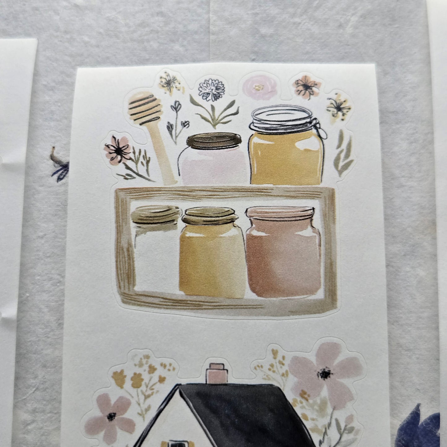 Notebook with honey jars and floral illustrations on a textured surface