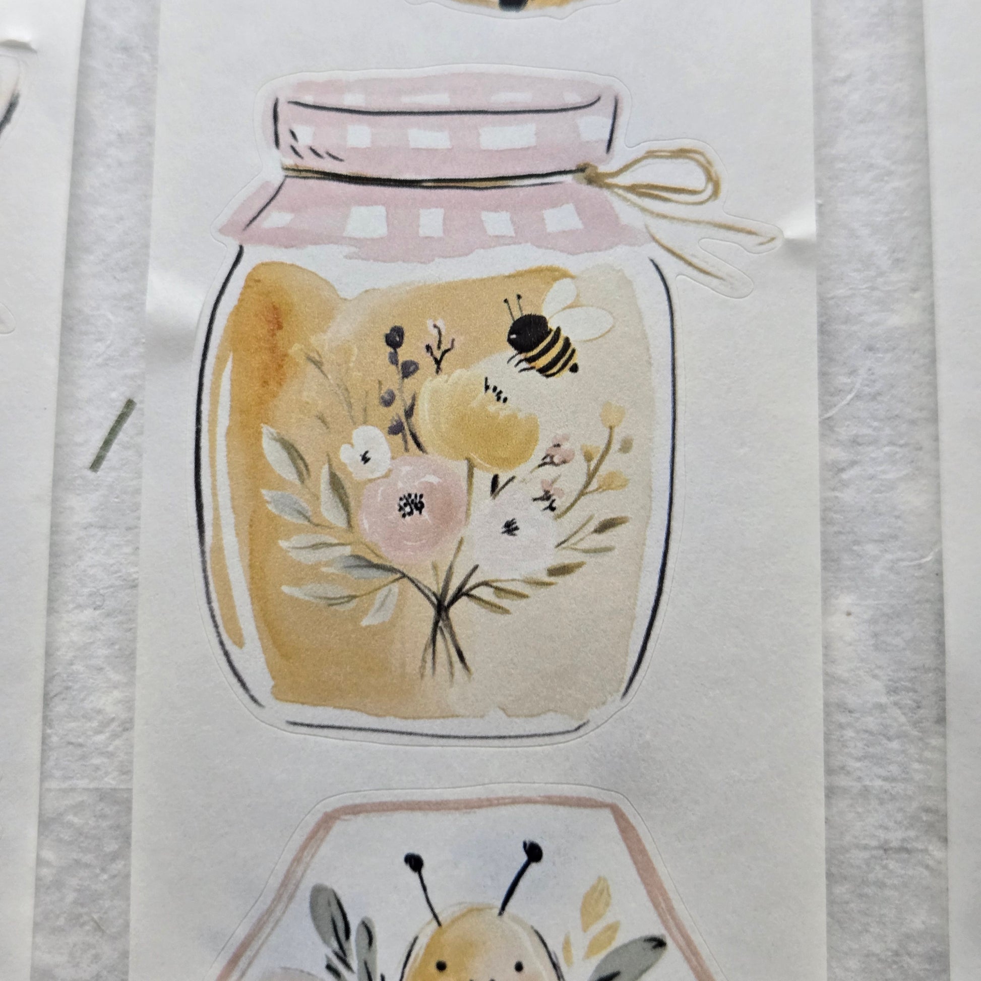 Decorative stickers with floral and bee designs on a white background