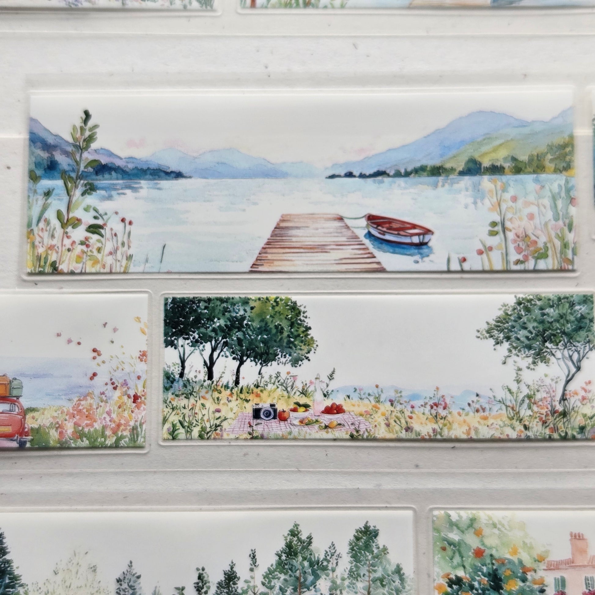 Decorative window with painted scenes of nature and a dock.