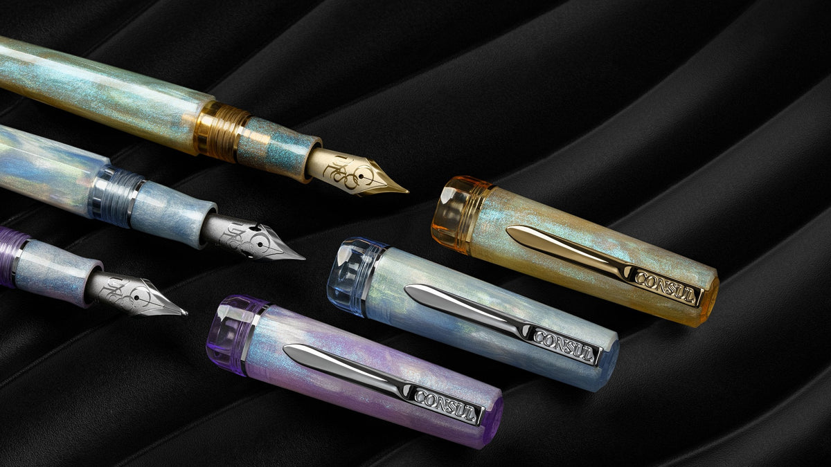 Consul Origin fountain pens in Alabaster, Glacier and Vesper resin with gold and chrome trim, shown uncapped with JoWo nibs