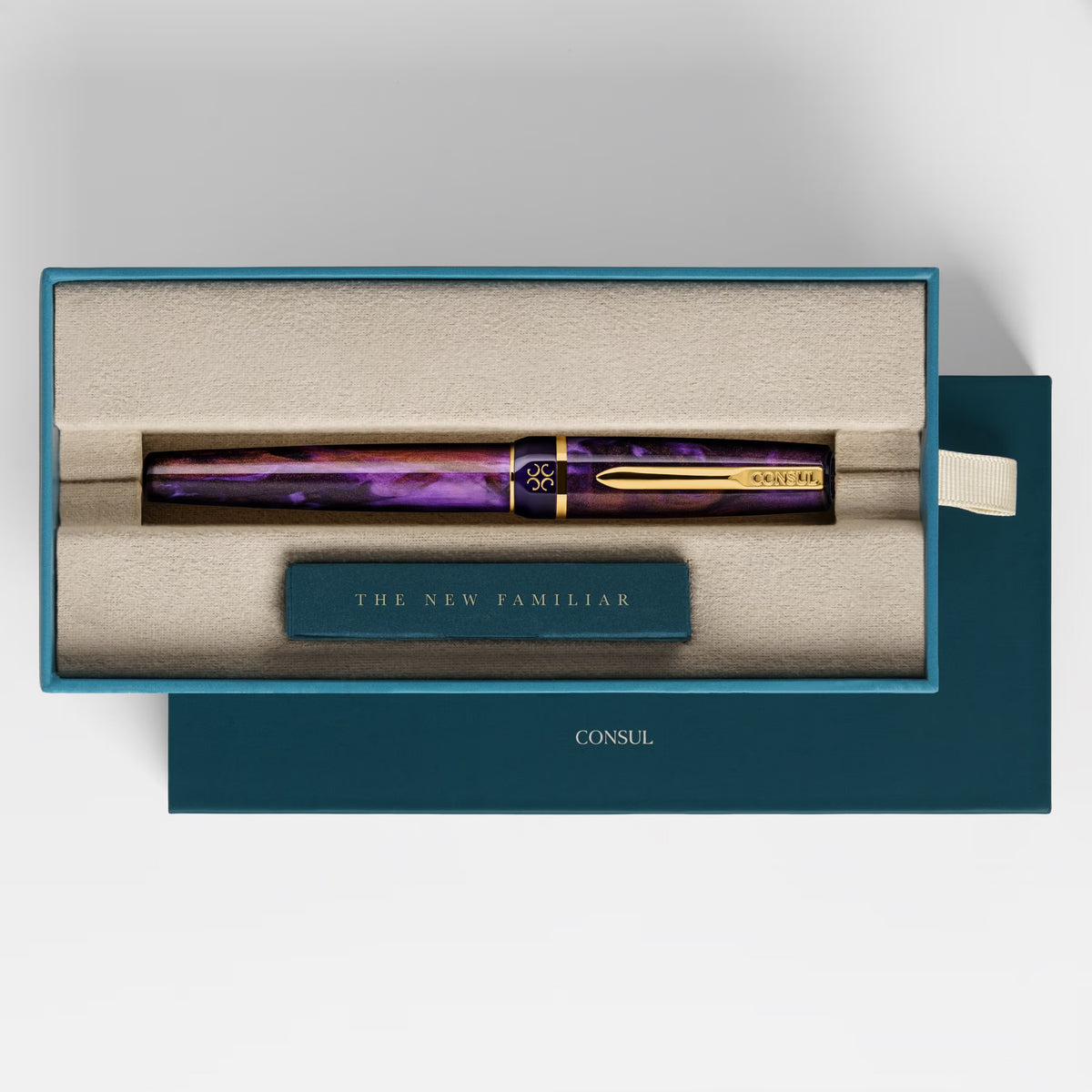 Consul Elan fountain pen in Claret, a swirled violet and wine-red resin with copper shimmer and gold trim, capped in its teal Consul presentation box
