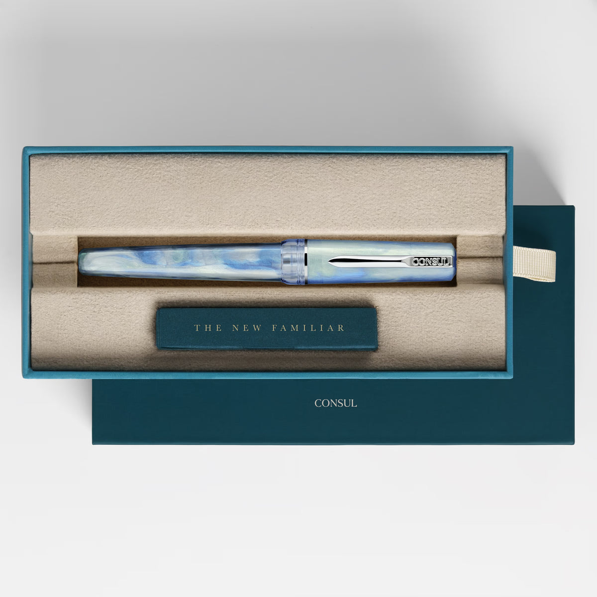 Consul Origin fountain pen in Glacier, a pale blue pearl resin with chrome trim and a blue cap finial, capped in its teal Consul presentation box