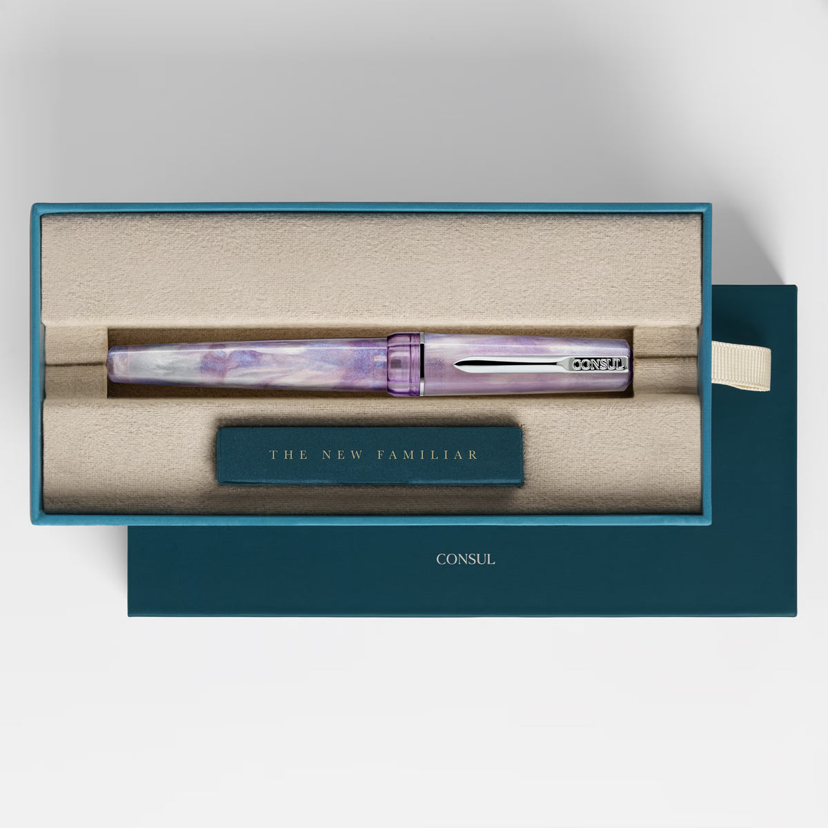 Consul Origin fountain pen in Vesper, a lavender pearl resin with pink and blue shimmer, chrome trim and a purple cap finial, capped in its teal Consul presentation box
