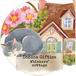 Circular sign with a cat, flowers, and a house, featuring 'London Gifties Whiskers' cottage'.